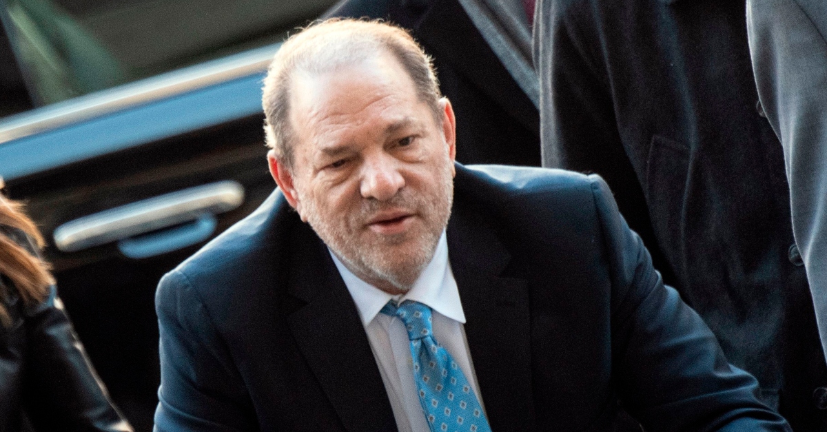Harvey Weinstein in a suit leaving a car