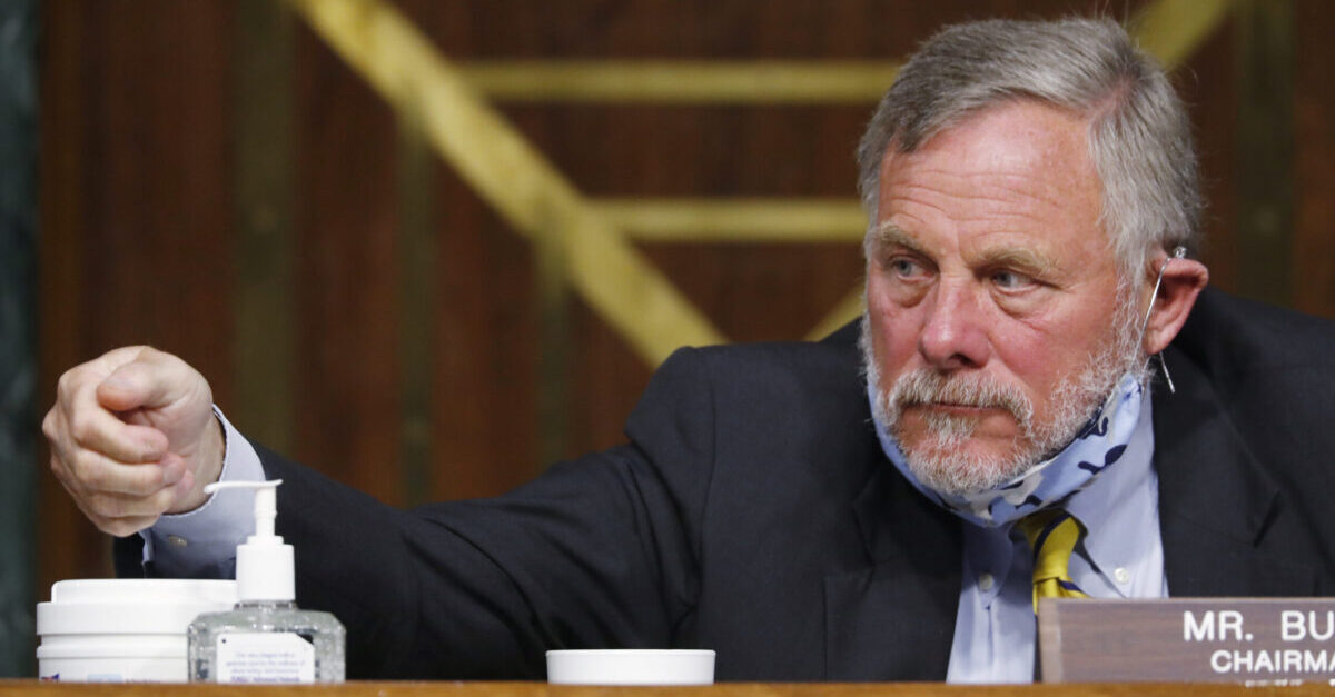 WASHINGTON, DC - MAY 05: Chairman Richard Burr, R-N.C., reaches for hand sanitizer at a Senate Intelligence Committee nomination hearing for Rep. John Ratcliffe, R-Texas, on Capitol Hill in Washington, Tuesday, May. 5, 2020. The panel is considering Ratcliffe's nomination for director of national intelligence.