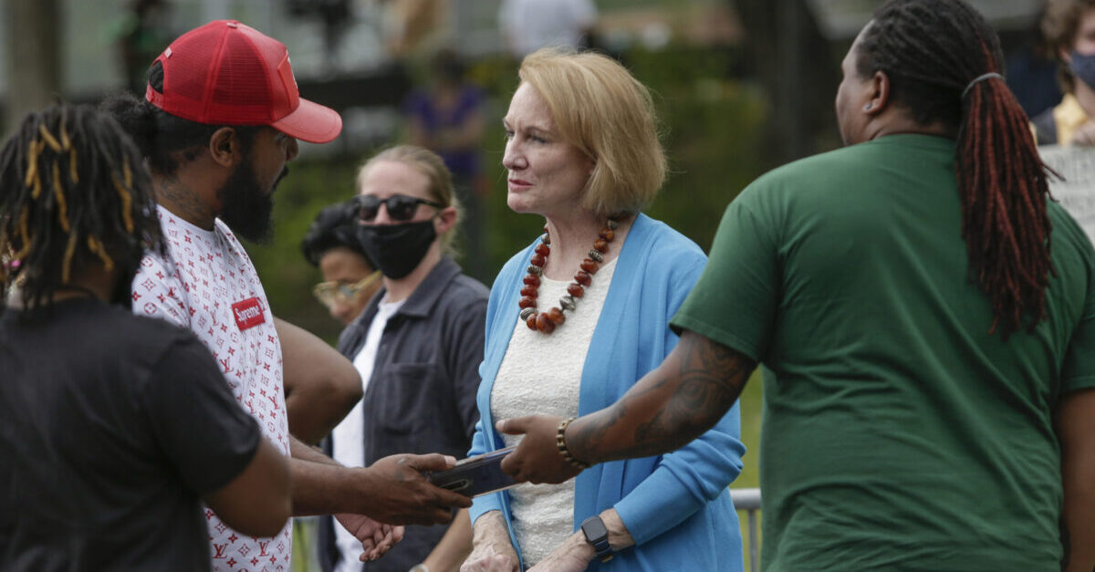 Seattle Mayor Jenny Durkan listens to Ezraniah Reed (L) and Ramisi Gomes, whose friend Iosia "Slim" Faletogo, 36, was killed by Seattle Police in 2018, about the need for police reform and accountability while back stage at the "The Next Steps" rally in Seattle, Washington on June 19, 2020. - The US marks the end of slavery by celebrating Juneteenth, with the annual unofficial holiday taking on renewed significance as millions of Americans confront the nation's living legacy of racial injustice. (Photo by Jason Redmond / AFP)