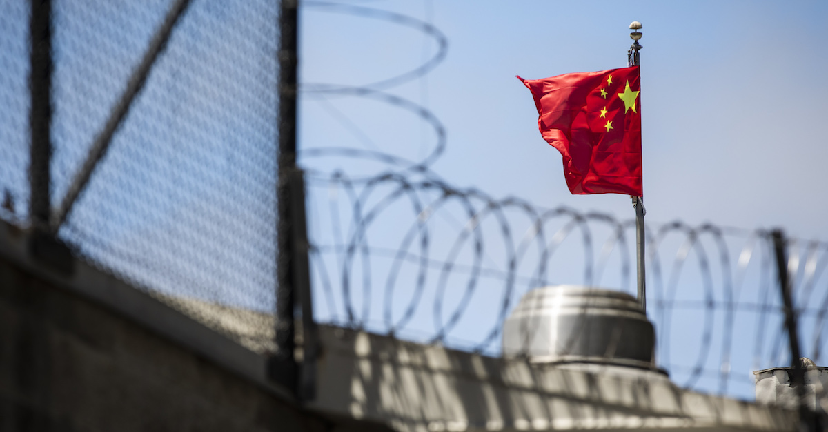 The flag of the People's Republic of China flies behind barbed wire at the Consulate General of the People's Republic of China in San Francisco, California on July 23, 2020. - The US Justice Department announced July 23, 2020 the indictments of four Chinese researchers it said lied about their ties to the People's Liberation Army, with one escaping arrest by taking refuge in the country's San Francisco consulate. (Photo by Philip Pacheco / AFP)