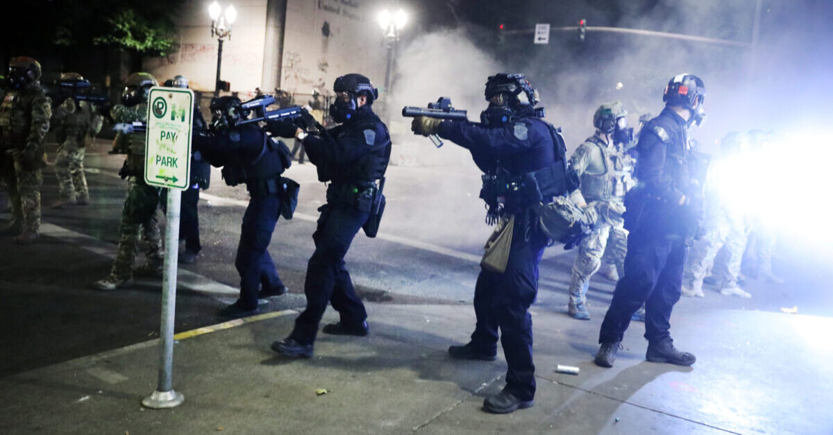 PORTLAND, OREGON - JULY 27: Federal police face off with protesters in front of the Mark O. Hatfield federal courthouse in downtown Portland as the city experiences another night of unrest on July 27, 2020 in Portland, Oregon. For over 57 straight nights, protesters in downtown Portland have faced off in often violent clashes with the Portland Police Bureau and, more recently, federal officers. The demonstrations began to honor the life of George Floyd and other black Americans killed by law enforcement and have intensified as the Trump administration called in the federal officers. 