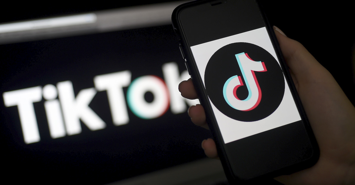 In this photo illustration, the social media application logo, TikTok is displayed on the screen of an iPhone on April 13, 2020, in Arlington, Virginia - TikTok has pledged $250 million to local organizations around the world supporting healthcare, education, and struggling communities impacted by the coronavirus pandemic.