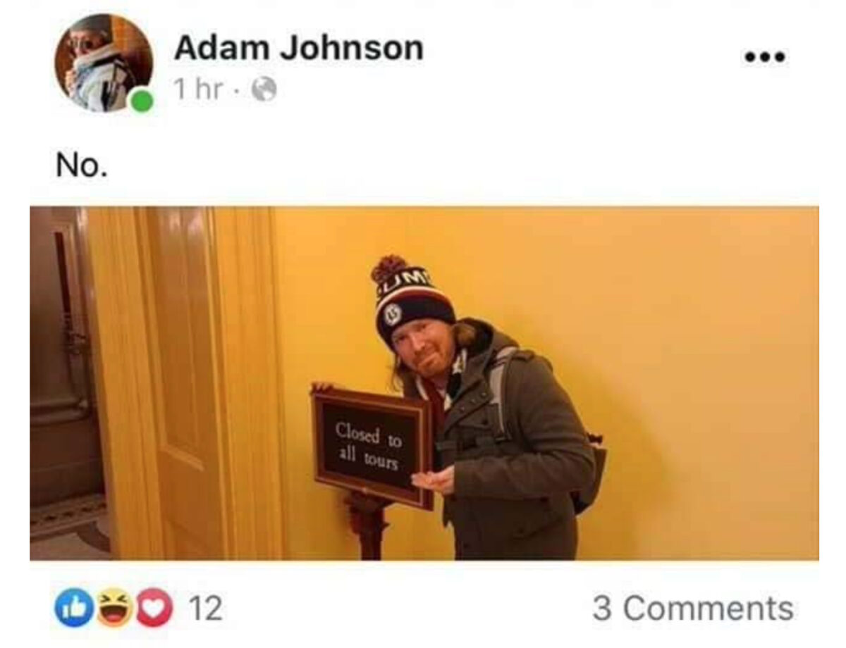 Adam Johnson Wipes Smile Off His Face For Post-Arrest Mugshot After U.S. Capitol Protests