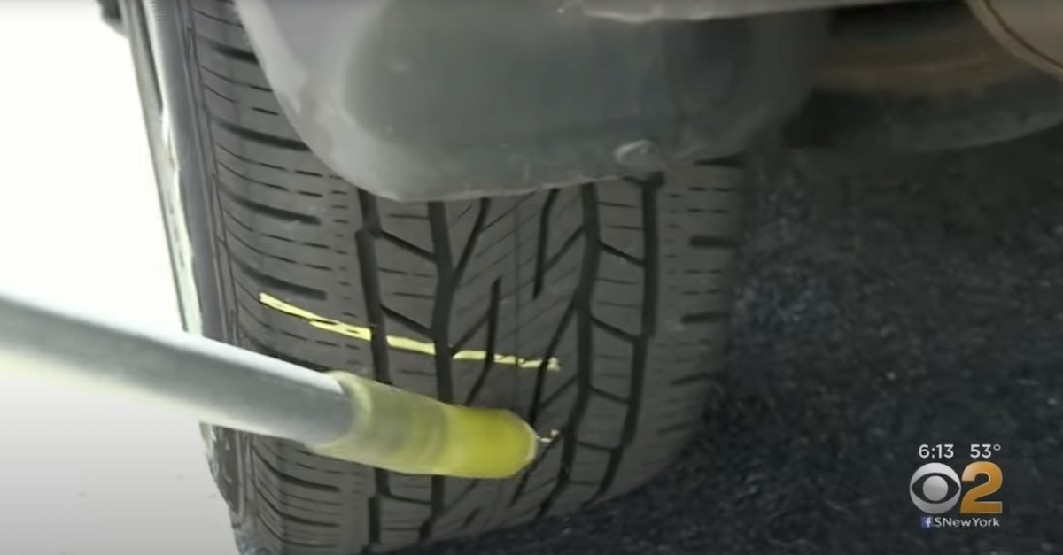 an officer chalking a tire