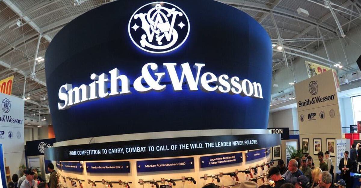 Convention goers look at weapons at the Smith and Wesson booth