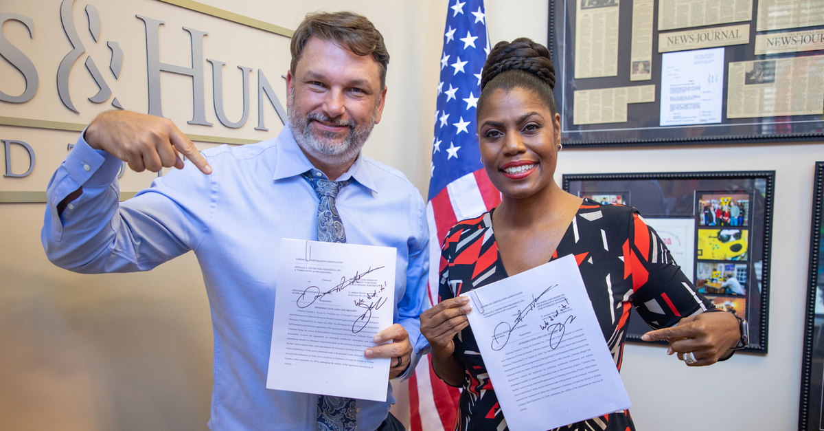 John M. Phillips and Omarosa Manigault Newman celebrate their win over Donald Trump