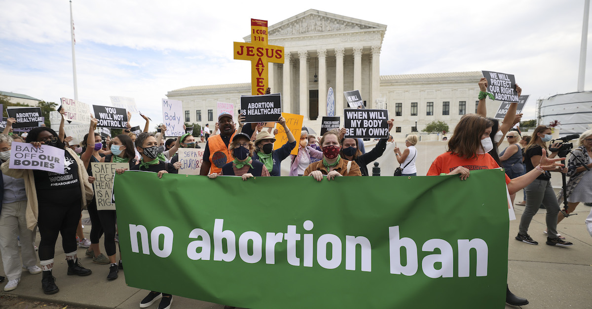Pro-choice and anti-abortion activists protest alongside each other during a demonstration outside of U.S. Supreme Court on October 4, 2021 in Washington, D.C. (Photo by Kevin Dietsch/Getty Images.)