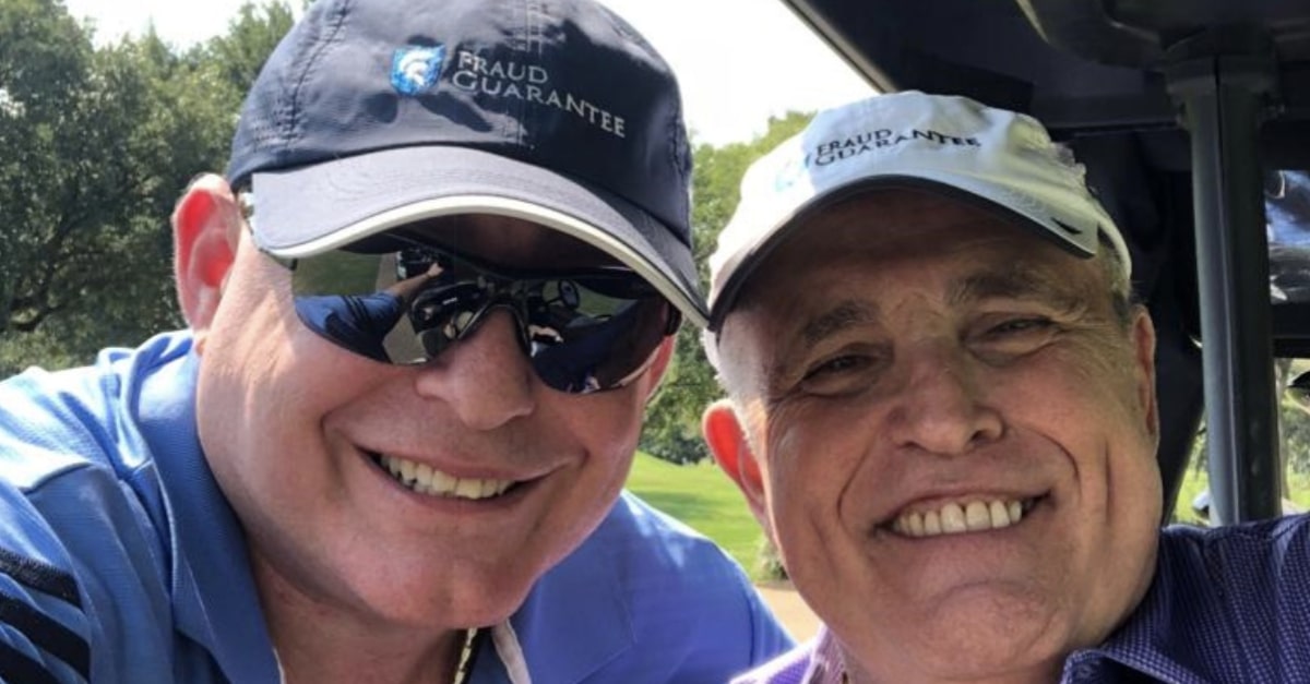 Lev Parnas and Rudy Giuliani wearing Fraud Guarantee hats