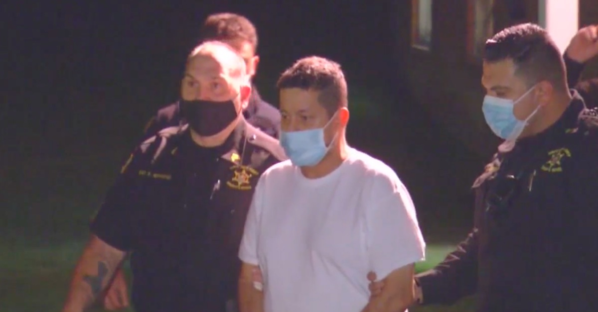 Nelson D. Patino being escorted by police