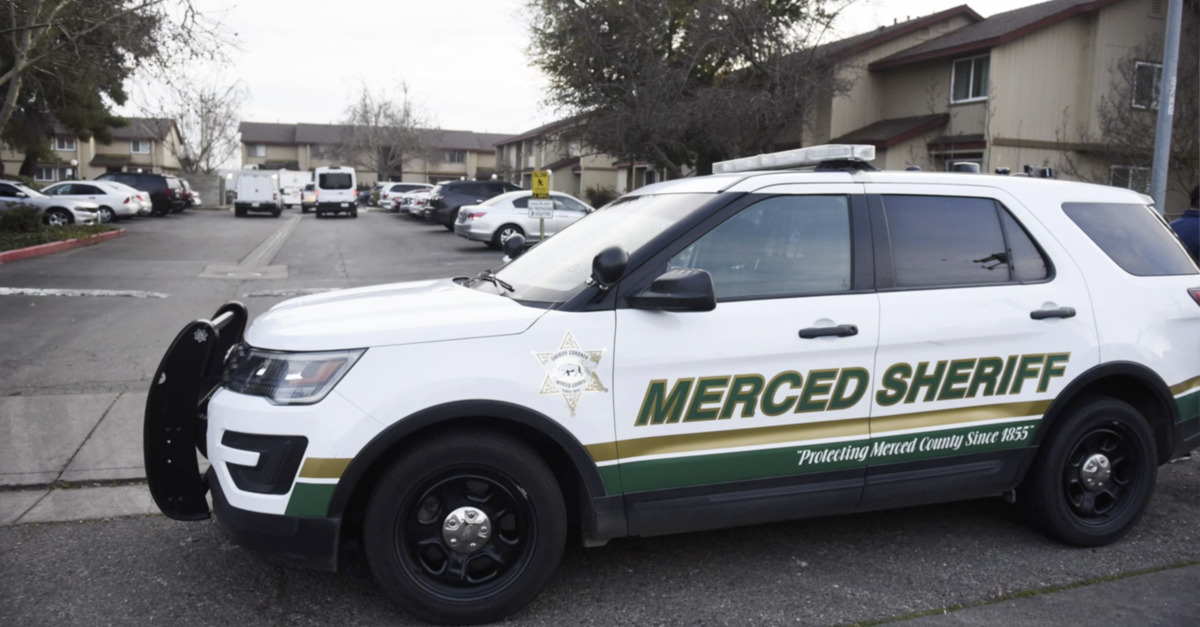 A law enforcement vehicle in front of an apartment complex in California where three dead children were discovered