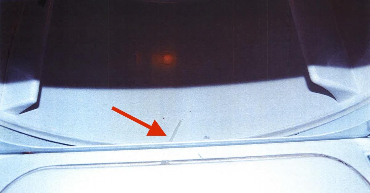 State's exhibit 71 shows the cap of a tranquilizer dart inside the Morphew clothes dryer. Law&Crime has added a red arrow to the image to point out the cap.  According to a different evidence photo, clothes were also found in the dryer, but they were removed before this image was taken by investigators.