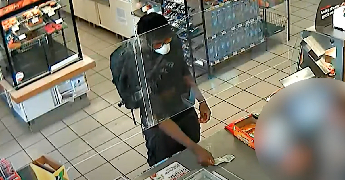 A wanted man identified as Shawn Laval Smith appears in a still frame taken from a 7-Eleven convenience store security camera. (Image via the LAPD/YouTube.)