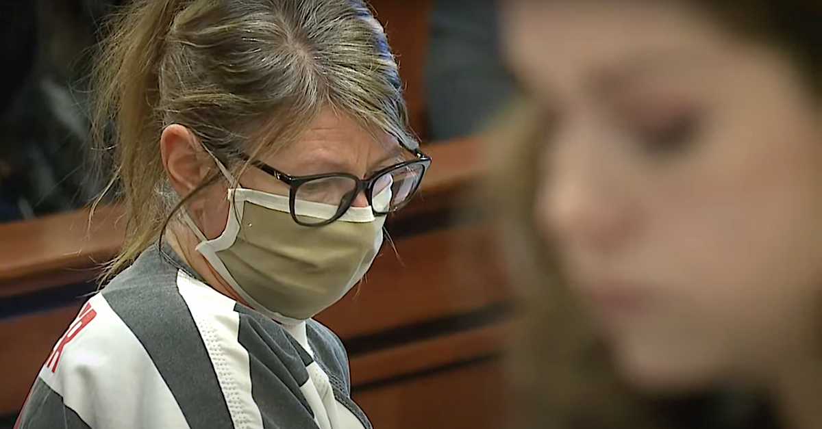 Jennifer Crumbley looks at paperwork while attorney Shannon Smith makes a point in court.