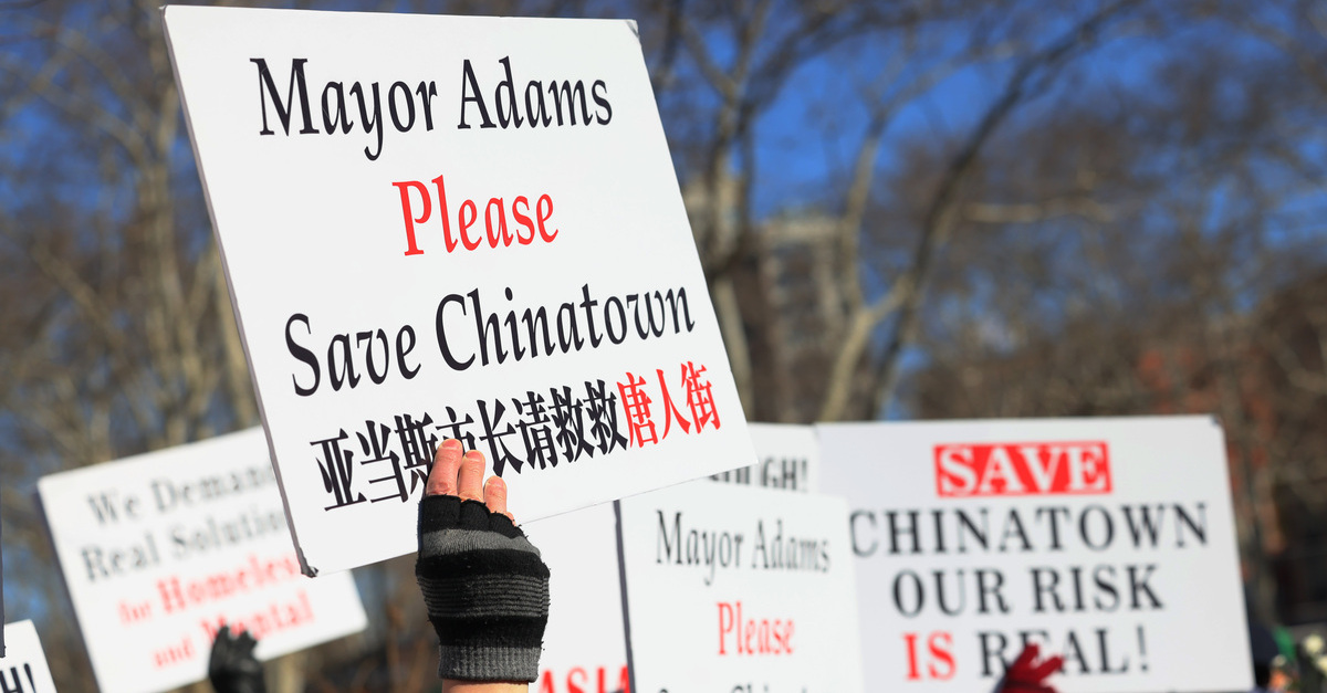 People hold signs as they gather for a rally protesting violence against Asian-Americans on Feb. 14, 2022 in the Chinatown neighborhood in New York City. Community members and leaders gathered in the wake of the murder of 35-year old Christina Yuna Lee. Lee was stabbed to death in her apartment by a man who allegedly followed her into her building.
