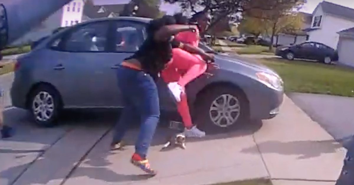 A still frame from Officer Nicholas Reardon's body camera video shows Ma'Khia Bryant (center, in black shirt and jeans) in the process of shoving a knife (visible in her right hand) toward Tionna Bonner (center, in pink). Officer Reardon opened fire split seconds later as Bryant's knife was near Bonner's head and neck. Bonner said she felt the blade against her skin.