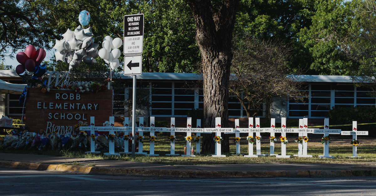 Crosses bearing the names of the victims of a mass shooting which killed 21 people, including 19 children, sit in front of Robb Elementary School on May 26, 2022 in Uvalde, Texas. (Photo by Jordan Vonderhaar/Getty Images.)