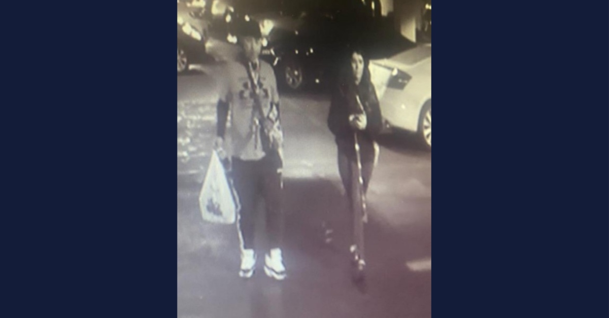 Surveillance footage of man walking with Anastasia Hamilton.
