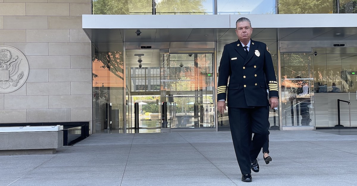 A man in a uniform walks out of the federal courthouse in downtown Los Angeles