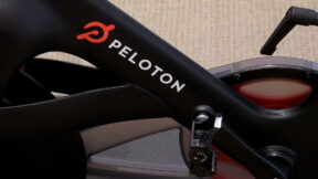 A Peloton bike features the company's name and logo.