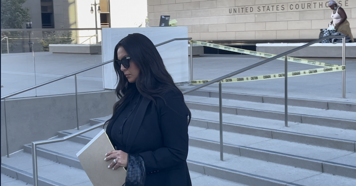 A woman in black who is Vanessa Bryant walks out of the federal courthouse in downtown Los Angeles