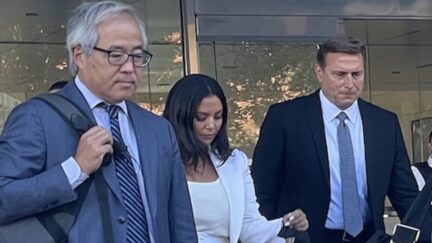 Vanessa Bryant, center, leaves the Los Angeles federal courthouse on Friday, Aug. 12, 2022, with her security guard (right) and her lawyer Luis Li (left) (photo by Meghann Cuniff for Law&Crime).