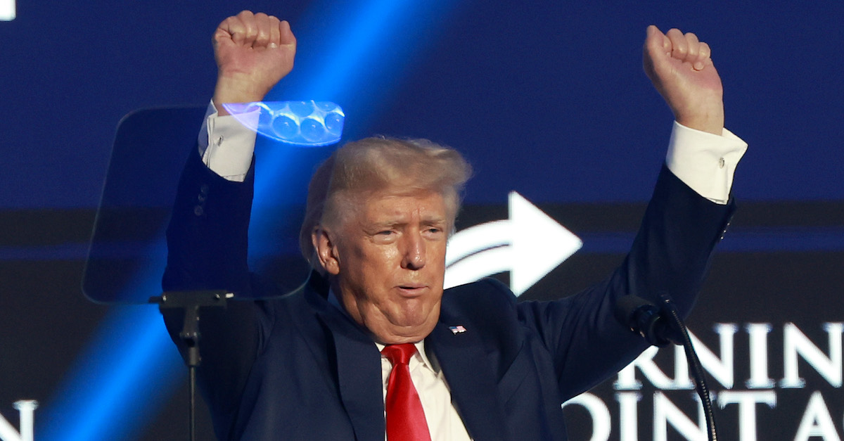 Donald Trump was photographed holding his hands above his head in a celebratory pose.