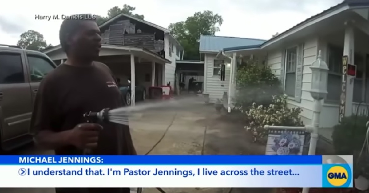 Pastor Michael Jerome Jennings is seen on police body-worn camera footage as he waters a neighbor's plants, as the neighbor had requested, before being arrested. 