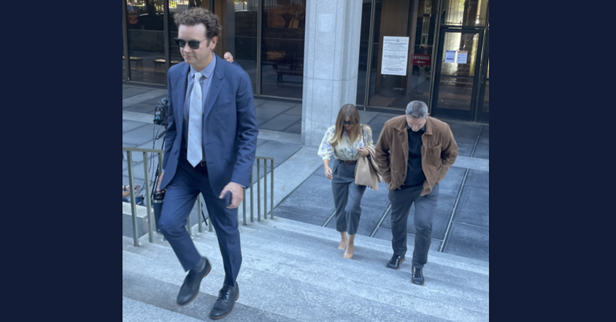 Danny Masterson walks up steps leaving a courthouse