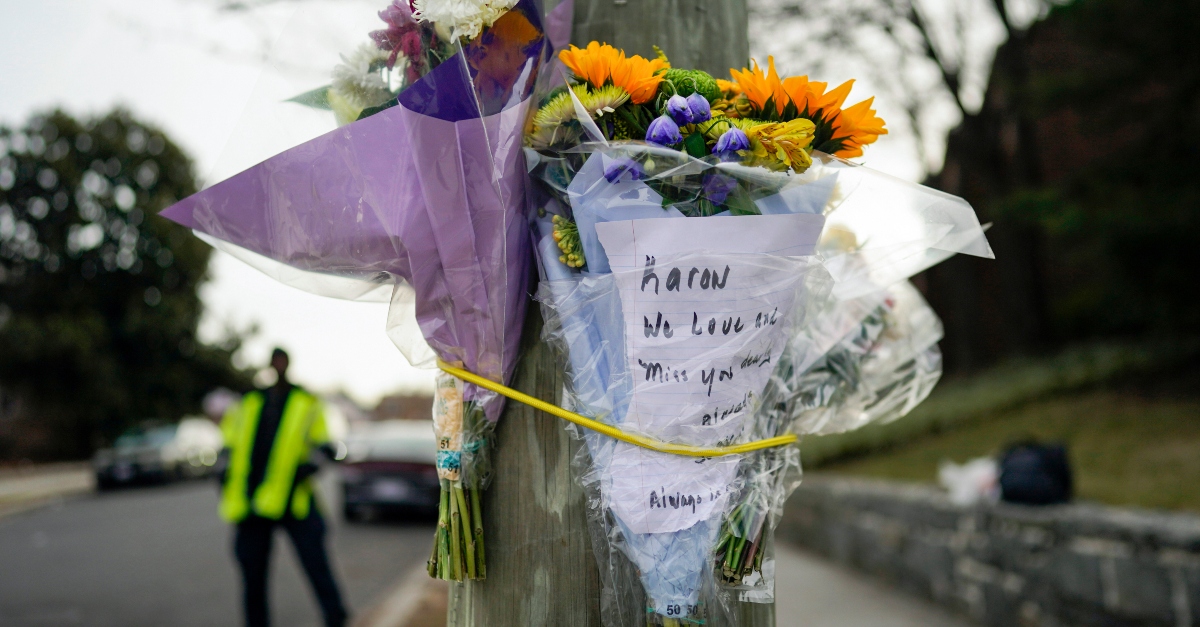 Flowers are secured to a pole as a memorial to Karon Blake, 13, on the corner of Quincy Street NE and Michigan Avenue NE in the Brookland neighborhood of Washington, Tuesday, Jan. 10, 2023. The note reads, "Karon we will love and miss you dearly." Karon Blake was shot and killed on the 1000 block of Quincy Street NE early morning Saturday, Jan. 7, 2023. (AP Photo/Carolyn Kaster)