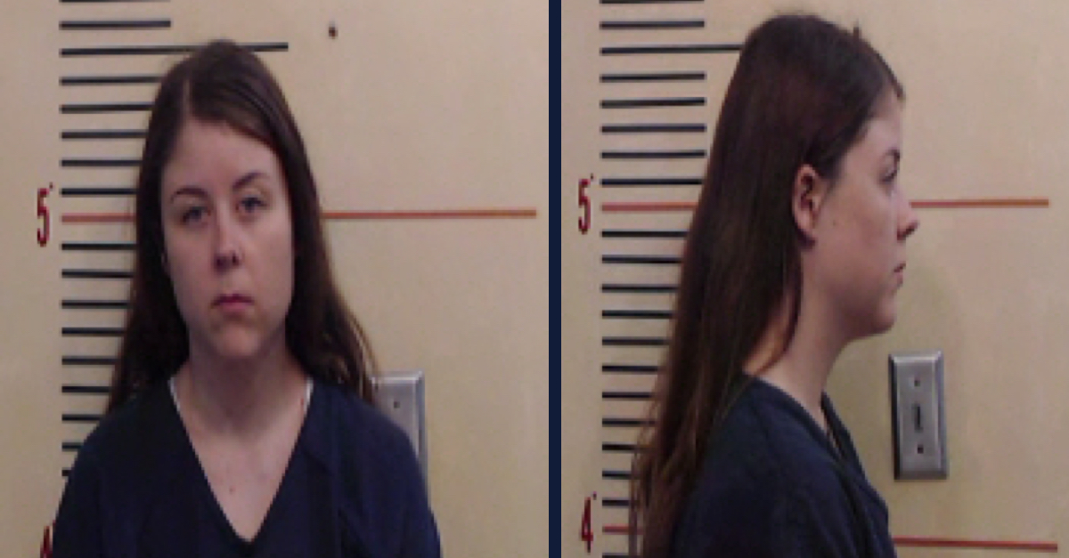Cala Richardson is wearing a blue shirt and has long straight brown hair. She is not smiling as she poses head-on and in profile for here booking photos.