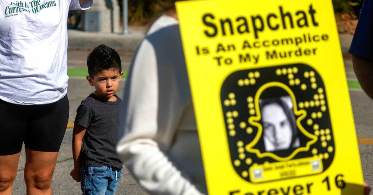 Jonathan Alvarez, 4, looks on as people against the sale of illicit drugs on Snapchat take part in a rally outside its headquarters to demand stricter restrictions on the popular social media app following fatal overdoses from the powerful opioid fentanyl in Santa Monica, Calif. Jan.21, 2022. (Ringo Chiu via AP)