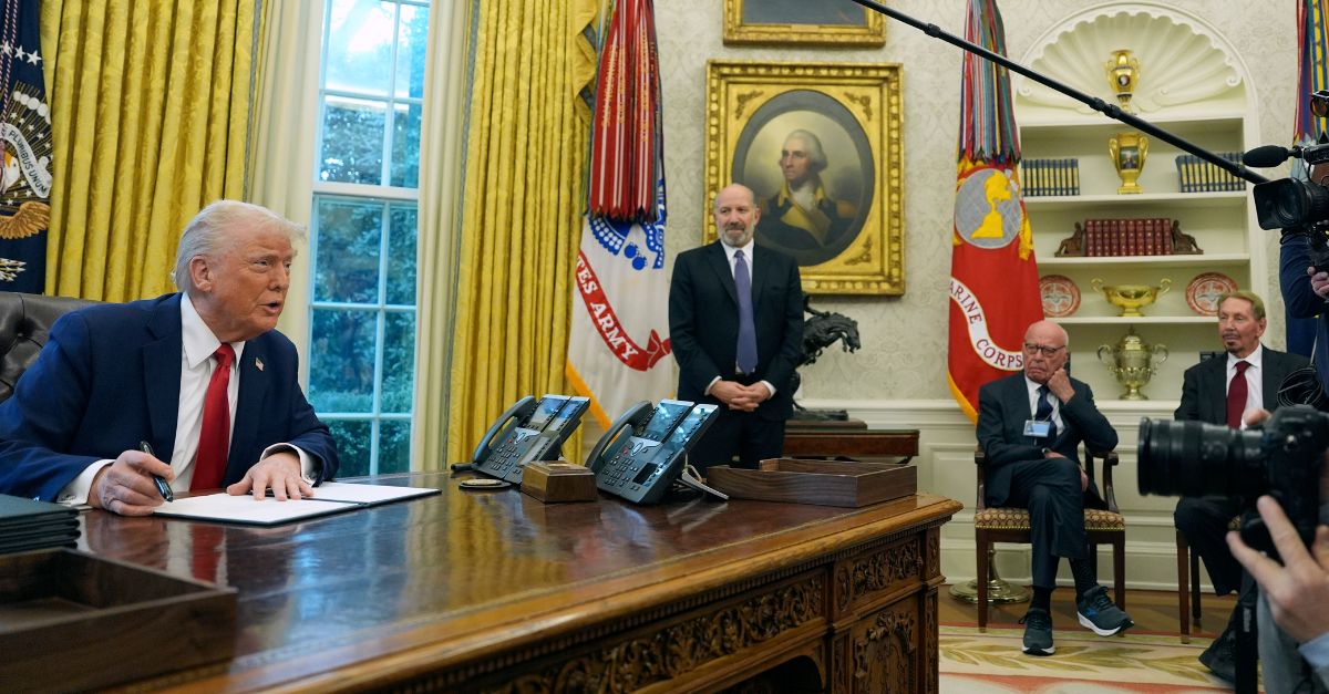 President Donald Trump, from left, speaks while signing an executive order as Commerce Secretary nominee Howard Lutnick, Rupert Murdoch and Larry Ellison, chairman and chief technology officer of Oracle Corporation, listen in the Oval Office of the White House, Monday, Feb. 3, 2025, in Washington. (AP Photo/Evan Vucci)