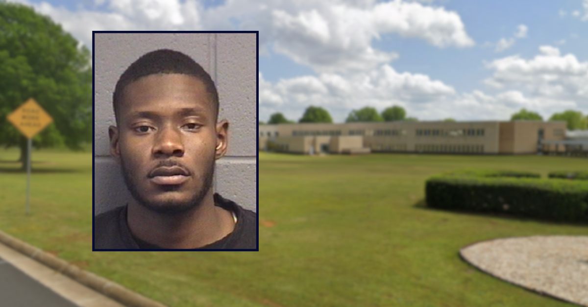 Quantraves Hall appears in a booking photo inset against an image of a state building in Georgia.