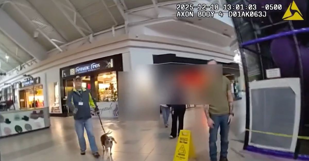 Scott Higbee walks his dog Darna in a mall in a still image from body-cam footage.
