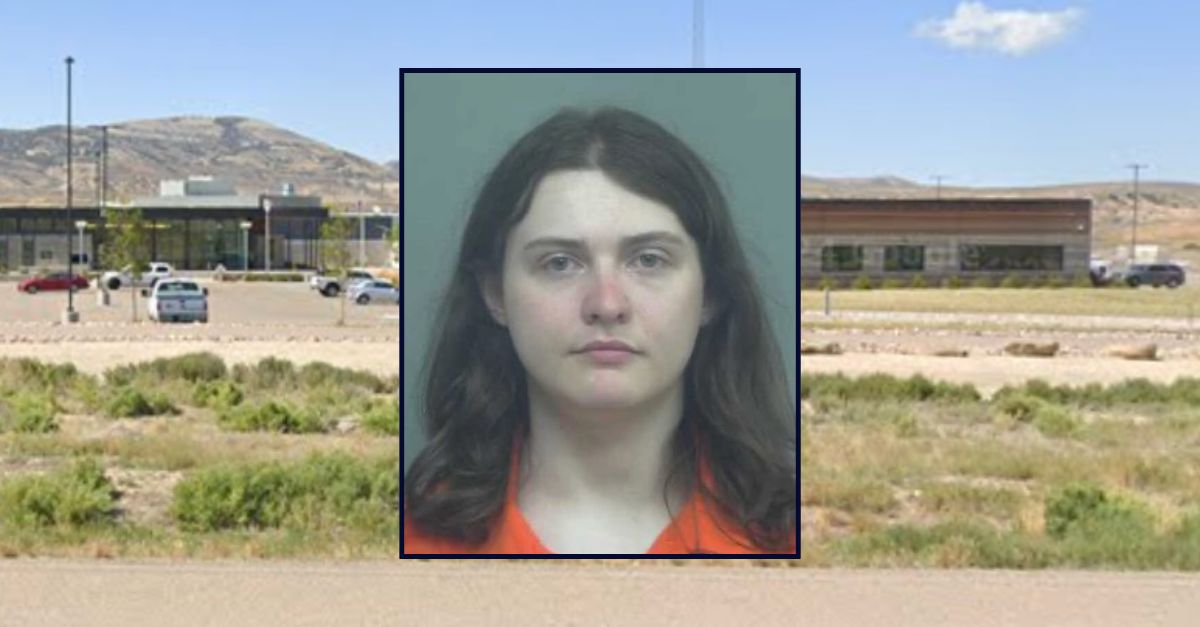 Jake Thomas Canestrini appears in a booking photo inset against an image of a criminal justice complex in Wyoming.